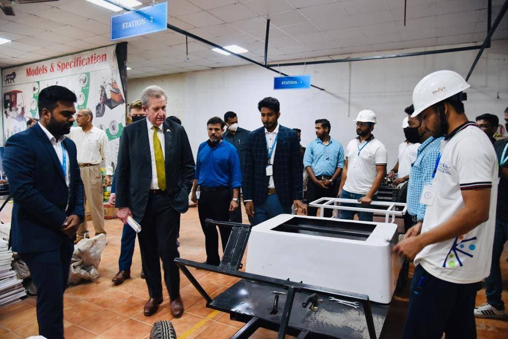 Students learning electric vehicle assembly in a Skyy Rider COE facility